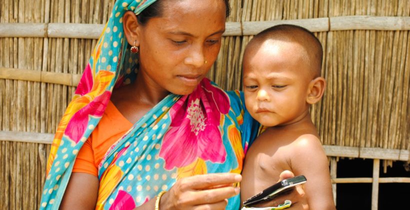 A Bangladeshi woman holding her son.